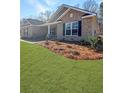 Brick house with black shutters, landscaping, and a grassy yard at 5301 Tuscany Dr, Douglasville, GA 30135