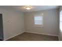Simple bedroom with neutral walls, vinyl flooring and one window at 973 Neal Nw St, Atlanta, GA 30314