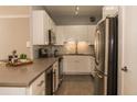 Modern kitchen with stainless steel appliances and white cabinets at 130 26Th Nw St # 211, Atlanta, GA 30309