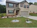 Two-story brick home with landscaped yard and two-car garage at 9843 Byrne Dr, Jonesboro, GA 30236