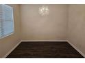 Empty dining room features dark hardwood floors and a modern chandelier at 9843 Byrne Dr, Jonesboro, GA 30236