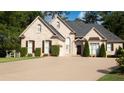 Brick home with a large driveway and landscaping at 255 Carriage Station Dr, Lawrenceville, GA 30046