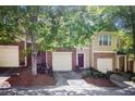 Townhouse triplex with attached garages, landscaping, and brick detailing at 2836 Ridgeview Dr, Atlanta, GA 30331