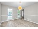 Bright dining room with hardwood floors and a modern chandelier at 1164 Interlaken Pass, Jonesboro, GA 30238