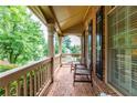 Inviting front porch with brick flooring and wooden chairs, offering a relaxing outdoor space at 2781 Willowstone Dr, Duluth, GA 30096