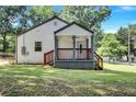 Newly renovated home with a charming front porch and well-maintained lawn at 2408 Hillcrest Dr, East Point, GA 30344