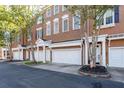 Row of brick townhouses with white garages and landscaping at 1275 W Spring St, Smyrna, GA 30080