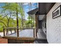 Modern deck with metal railing overlooking a wooded area at 2228 Old Dallas Sw Rd, Marietta, GA 30064