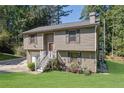 Two story house with attached garage and a green lawn at 4693 Hairston Crossing Rd, Stone Mountain, GA 30083