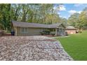 Ranch style home with a large yard and driveway at 3225 Fern Dr, Tucker, GA 30084