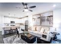 Open concept living room and kitchen with neutral tones and modern finishes at 3351 Orwell Way # 2105, Cumming, GA 30041