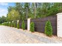Privacy fence with dark wood, white brick, and manicured greenery at 2635 Camp Branch Rd, Buford, GA 30519