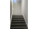 Indoor staircase with carpeted steps and handrail at 4769 Snap Creek Ln, Decatur, GA 30035