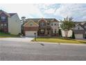 Two story brick home with a large front yard at 3770 Falling Leaf Ln, Cumming, GA 30041