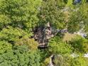 An aerial view of the home surrounded by lush green trees at 5051 Heather Se Rd, Smyrna, GA 30082