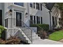 Brick front porch with black metal railings leading to a black front door at 3126 Crestmont Nw Way, Kennesaw, GA 30152