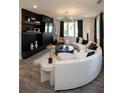 Modern living room showcasing a curved sofa and a sleek media wall at 392 Pratt Se Dr # 2012, Atlanta, GA 30315