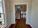 View of a staircase leading to an open living area with hardwood floors at 108 Stonehouse Dr, Cumming, GA 30040