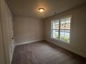 Spacious bedroom with carpeted floor and large window at 328 Willow Cv, Canton, GA 30114