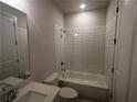 Clean bathroom with a bathtub, shower, and white tile at 328 Willow Cv, Canton, GA 30114