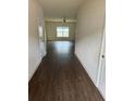 Long hallway with dark brown wood-look flooring at 521 Moline Way, Locust Grove, GA 30248