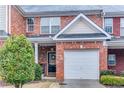 Brick front exterior of townhome with attached garage at 1829 Willow Branch Nw Ln # M, Kennesaw, GA 30152