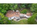 Unique guitar-shaped house with a large yard and surrounding trees at 115 Wilkins Rd, Fayetteville, GA 30214