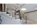 Modern staircase with cable railing and light wood accents at 115 Wilkins Rd, Fayetteville, GA 30214
