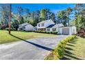 Two story home with attached garage and manicured hedges at 2225 Pleasant Hill Rd, Atlanta, GA 30349