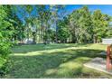 Spacious backyard with lush lawn and tree lined perimeter at 2225 Pleasant Hill Rd, Atlanta, GA 30349