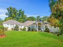 Brick home with a large front yard and mature trees at 1565 Mountain Shadow Trl, Stone Mountain, GA 30087
