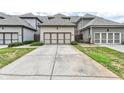 Two-car garage with driveway and landscaping at 3517 Village Park Nw Way, Kennesaw, GA 30144