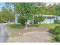 View of the home from the side yard, showing the covered porch at 4310 Bryan Se Ln, Acworth, GA 30102