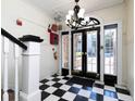 Bright entryway with black and white checkered floor and chandelier at 242 12Th Ne St # 8, Atlanta, GA 30309