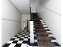 Elegant staircase with a black and white checkered floor at 242 12Th Ne St # 8, Atlanta, GA 30309