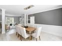 Bright dining room features a large wooden table and white chairs, with an open view to the living room at 4385 Wieuca Ne Rd, Atlanta, GA 30342