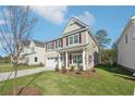 Two-story house with gray siding, white trim, and a landscaped lawn at 11824 Rizvan Pl, Covington, GA 30014