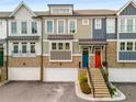 Modern three-story townhome with attached two-car garage and charming front porch at 370 Thrasher St # 2, Norcross, GA 30071