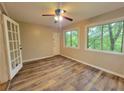 Sunroom with wood-look floors, windows, and ceiling fan at 181 Barone Nw Pl, Atlanta, GA 30327