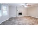 Living room featuring a brick fireplace and wood-look floors at 1507 Hillside Se Dr, Conyers, GA 30094