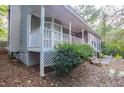 Gray brick house with white porch and landscaping at 1507 Hillside Se Dr, Conyers, GA 30094