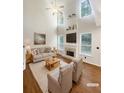 Spacious living room with hardwood floors, fireplace, and large windows at 4060 Willowmere Pointe Nw, Kennesaw, GA 30144