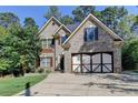 Brick two-story house with three-car garage at 1984 Buford Dam Rd, Buford, GA 30518