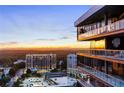 Stunning aerial view of the cityscape at sunset, showcasing the building's location and surrounding area at 3107 Peachtree Road Ne Unit #1803, Atlanta, GA 30305