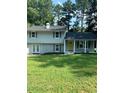 Newly renovated two-story home with a yellow door at 5364 Cedar Rock Dr, Stonecrest, GA 30038
