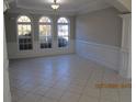 Spacious dining room with tile floors and wainscoting at 354 Mansfield Way, Stockbridge, GA 30281