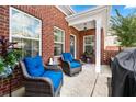 Cozy patio with wicker chairs and a grill at 205 Villa Park Cir # 205, Stone Mountain, GA 30087