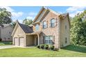 Two-story house with brick and siding accents, two-car garage, and manicured lawn at 1185 Paramount Dr, Mcdonough, GA 30253