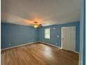 Light and airy living room with light wood floors and blue walls at 8165 Thompson St, Douglasville, GA 30134