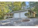 House exterior with two-car garage and landscaping at 443 Creekwood Pass, Dallas, GA 30157